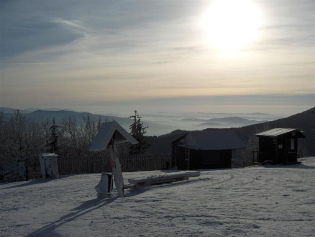 Javorový Vrch – Třinec in Czech Republic - the sun is shining over the snow covered mountains.