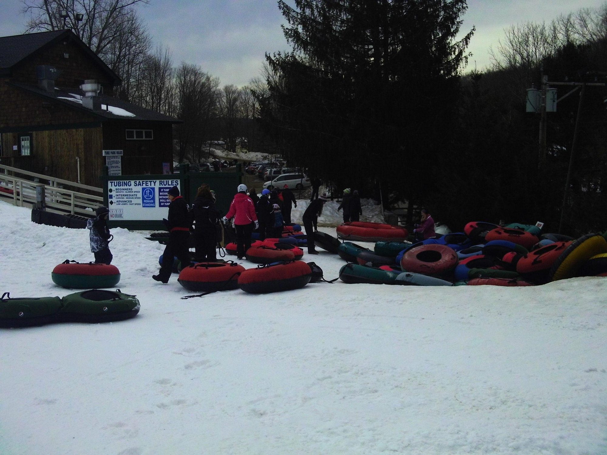 A vibrant winter sports scene in Woodbury, Connecticut showcasing a bustling ski resort and a chalet amidst a picturesque snowy landscape.