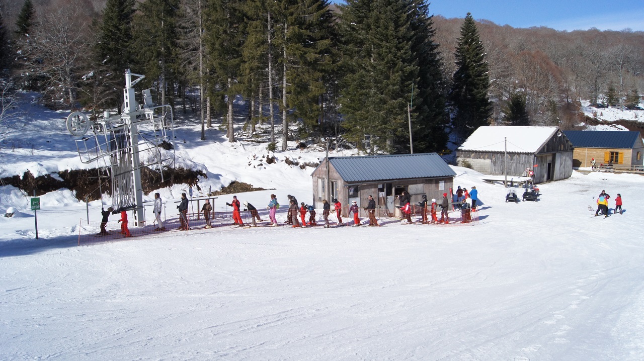 Saint-Urcize in France - a group of people skiing down a hill.