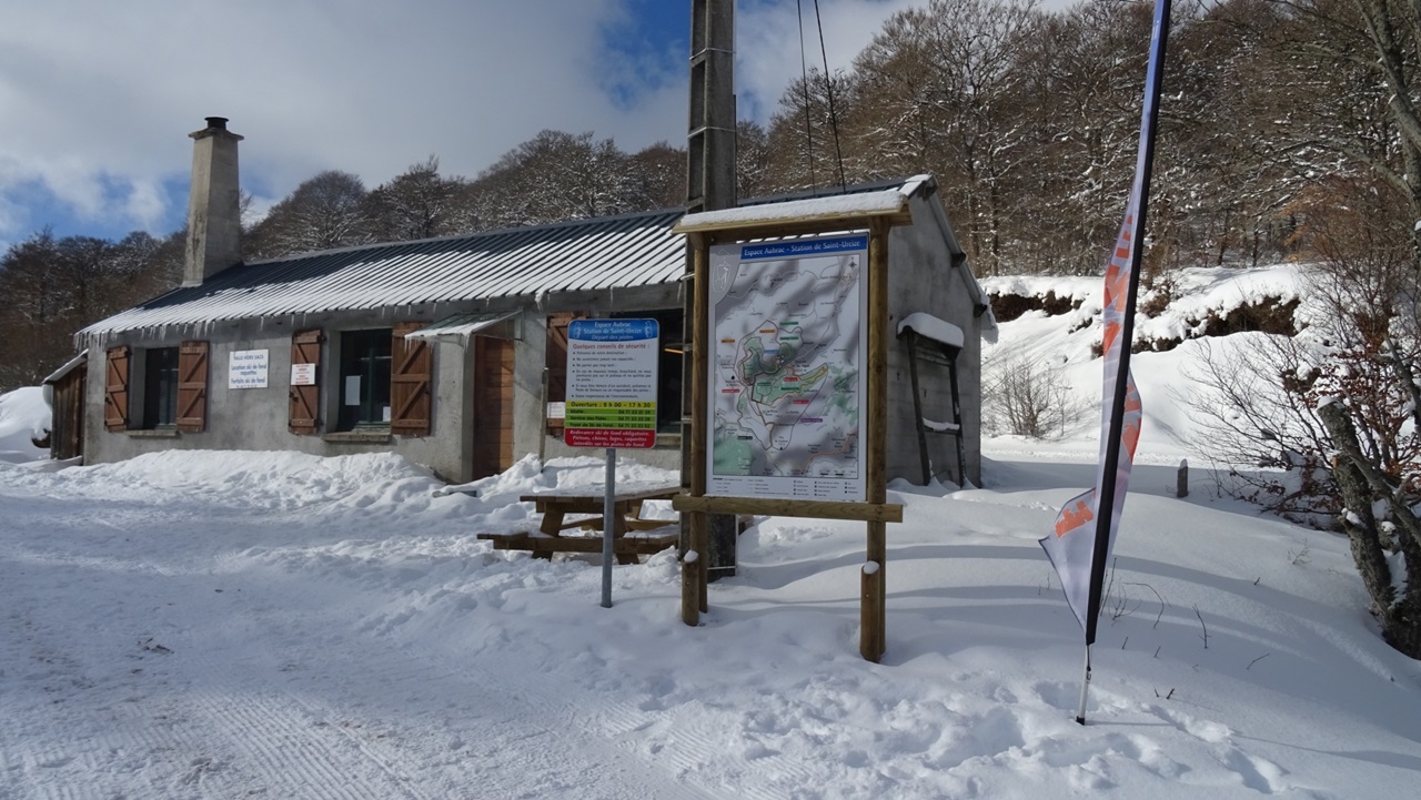 Saint-Urcize in France: a small building with a sign in the snow.