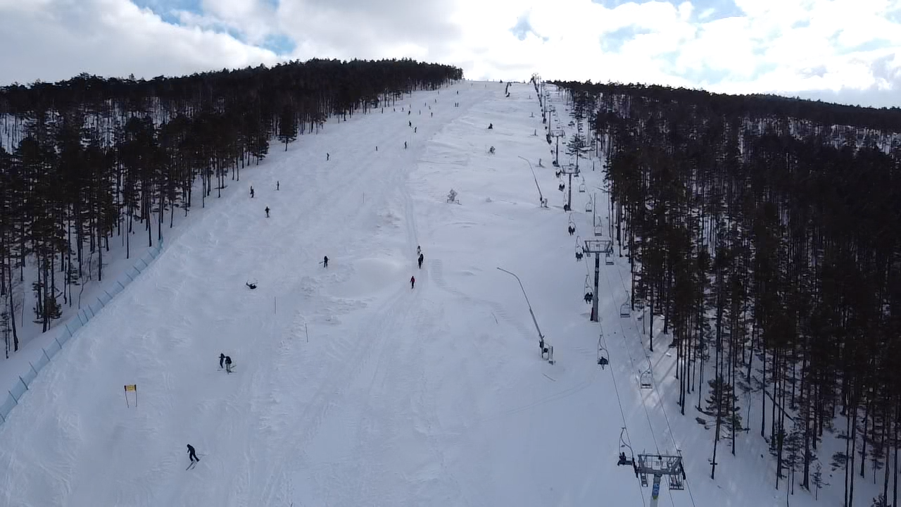 Crni Vrh in Serbia - a group of people skiing down a mountain.