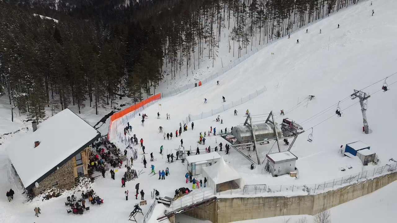 Crni Vrh in Serbia - a group of people standing on top of a ski slope.