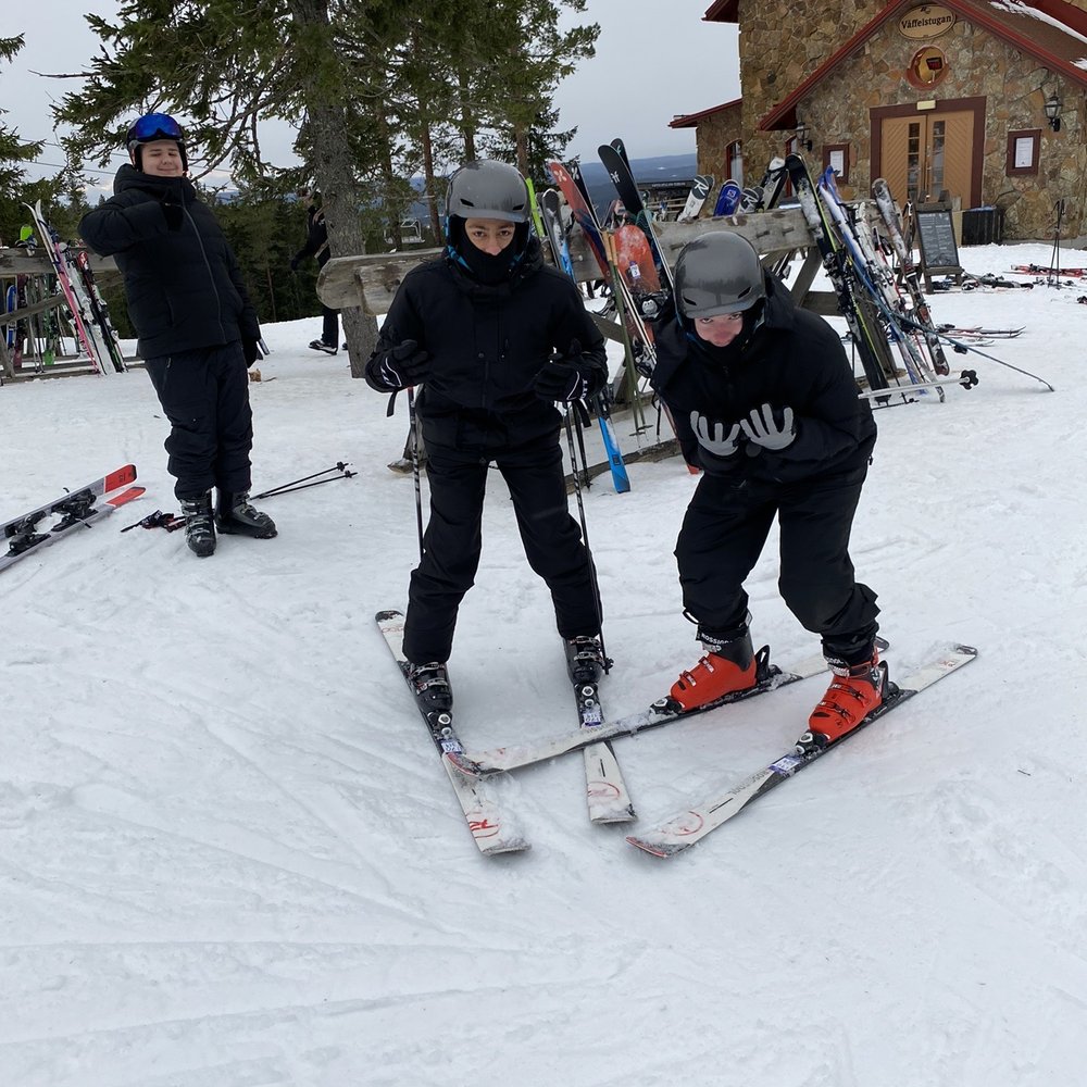Gillersklack in Sweden - a group of people riding ski boards down a slope.