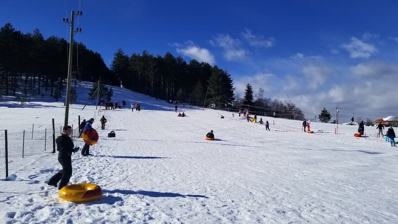 Sneško Goč in Serbia - a group of people riding down a snow covered slope.