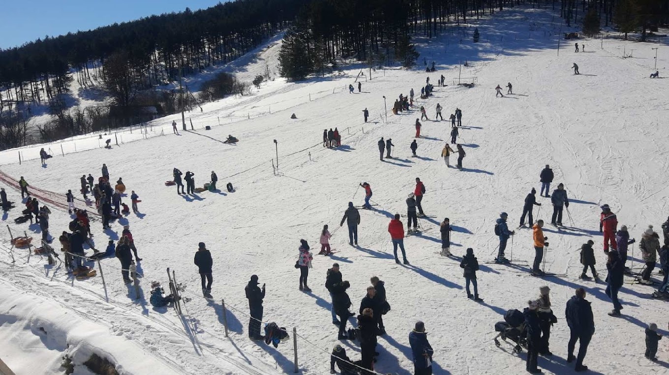 Sneško Goč in Serbia - a group of people skiing down a snowy slope.