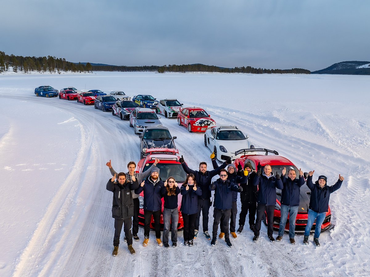 Vittjåkk in Sweden - a group of people standing in the snow with their cars.