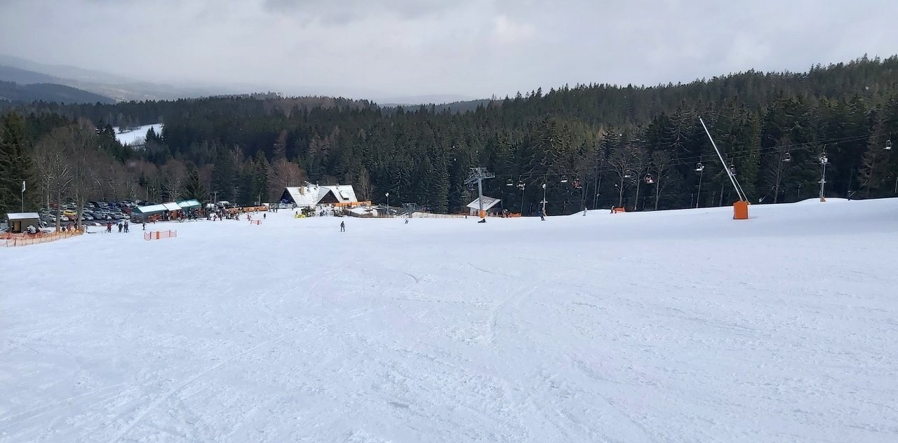Zadov – Kobyla in Czech Republic - a snow covered ski slope with trees in the background.