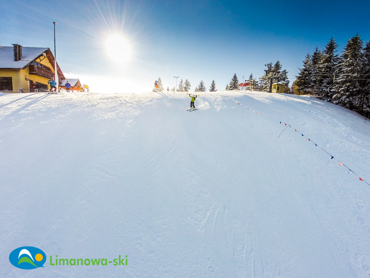 Limanowa in Poland - a person skiing down a snow covered hill.