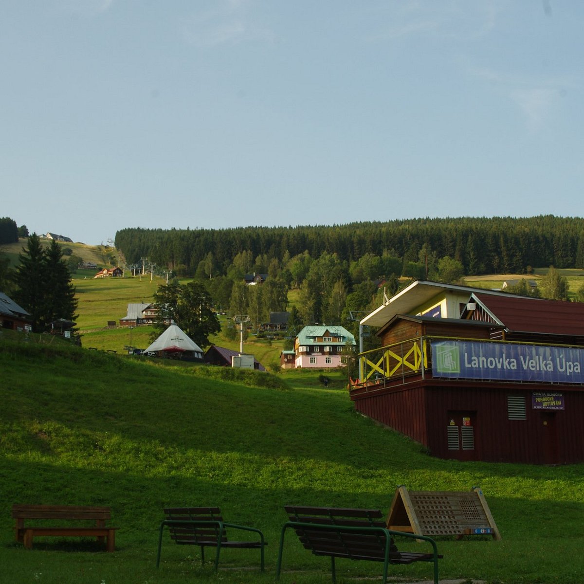 Velká Úpa in Czech Republic: a red building sitting on top of a lush green hillside.