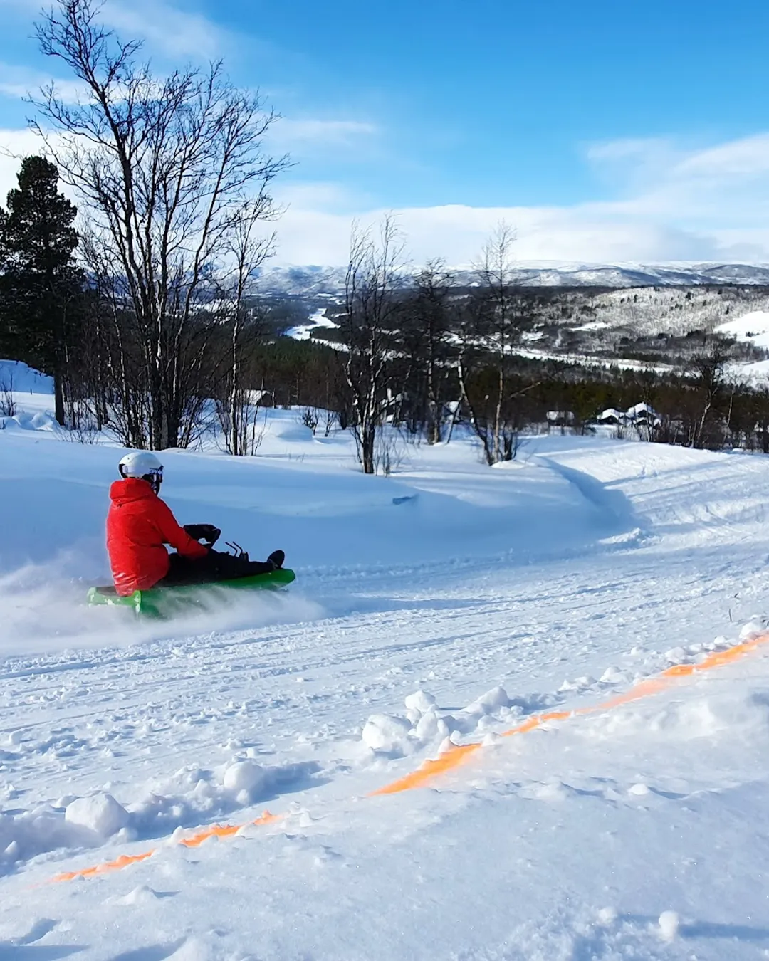 Dagali Fjellpark in Norway - a person on a snowboard in the snow.
