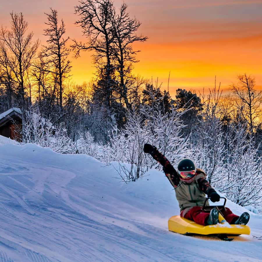 Dagali Fjellpark in Norway - a person on a snowboard in the snow.