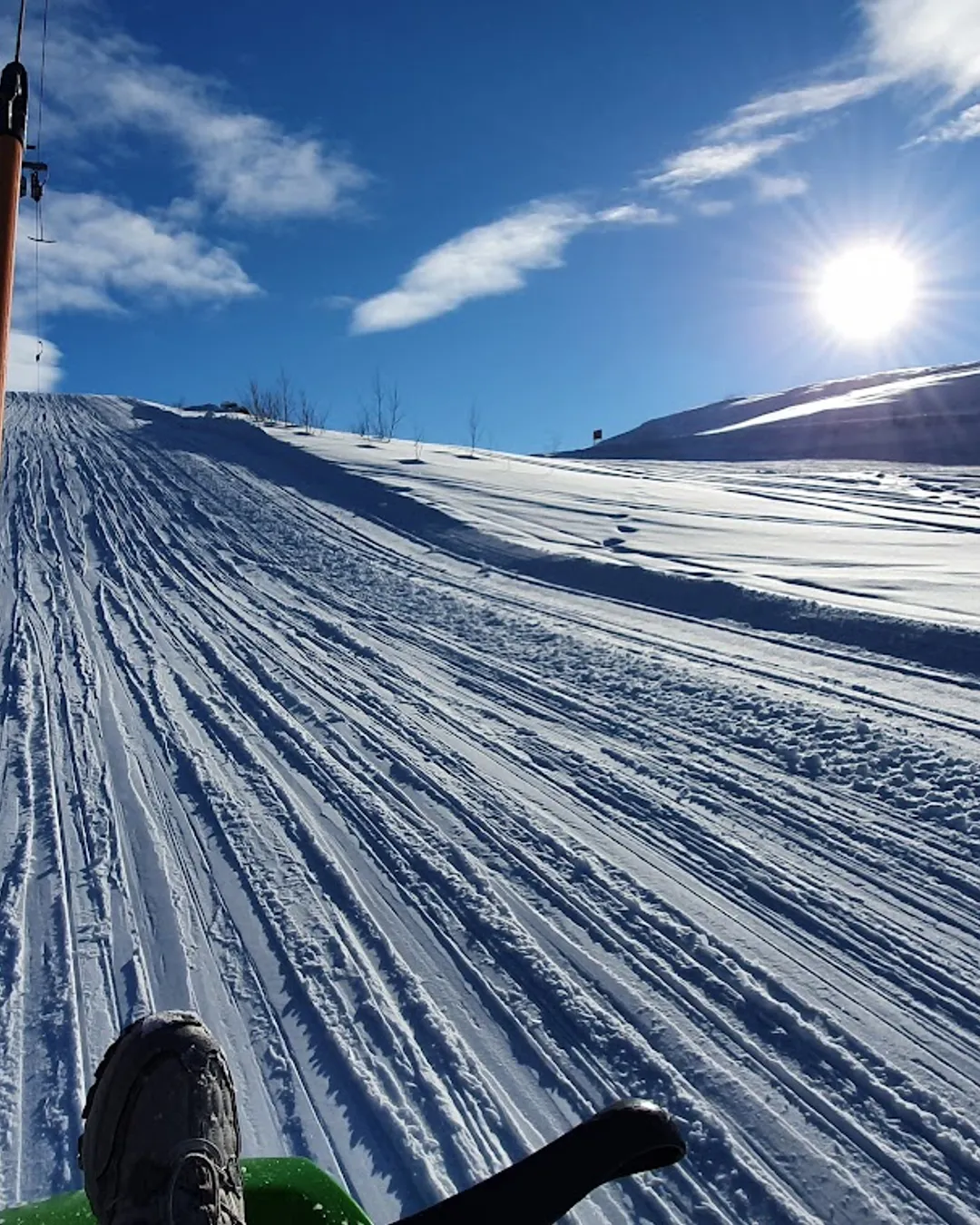 Dagali Fjellpark in Norway - a person riding a snowboard down a snow covered slope.