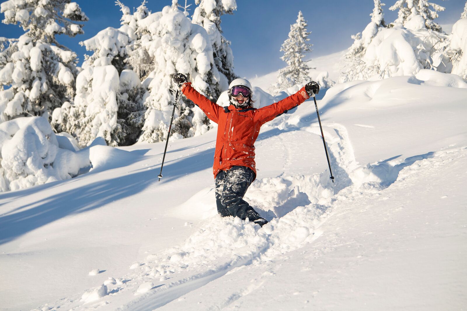 Dagali Fjellpark in Norway - a person in a red jacket skiing down a snowy slope.