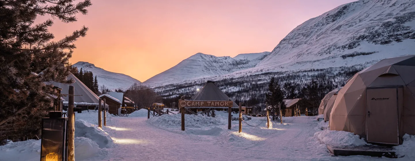 Tromsø in Norway - a snowy scene with tents in the snow.
