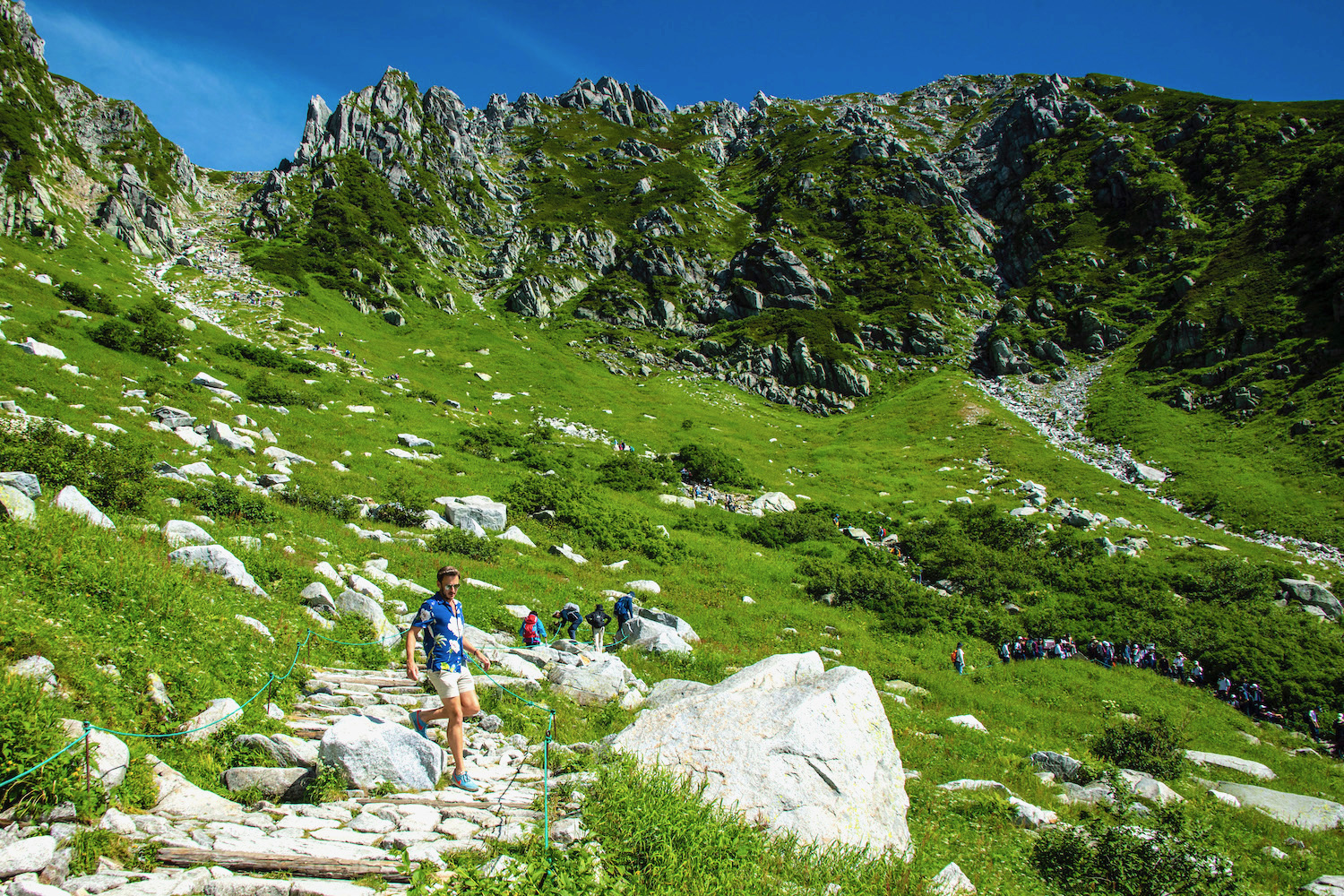 Chuo Alps Senjojiki in Japan - a group of people hiking up a rocky trail.