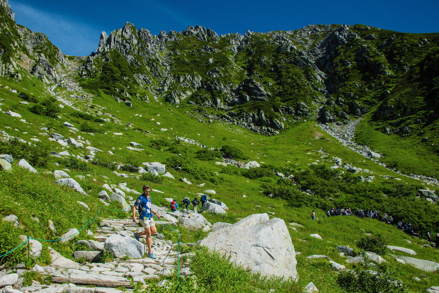 Chuo Alps Senjojiki in Japan - a group of people hiking up a rocky trail.