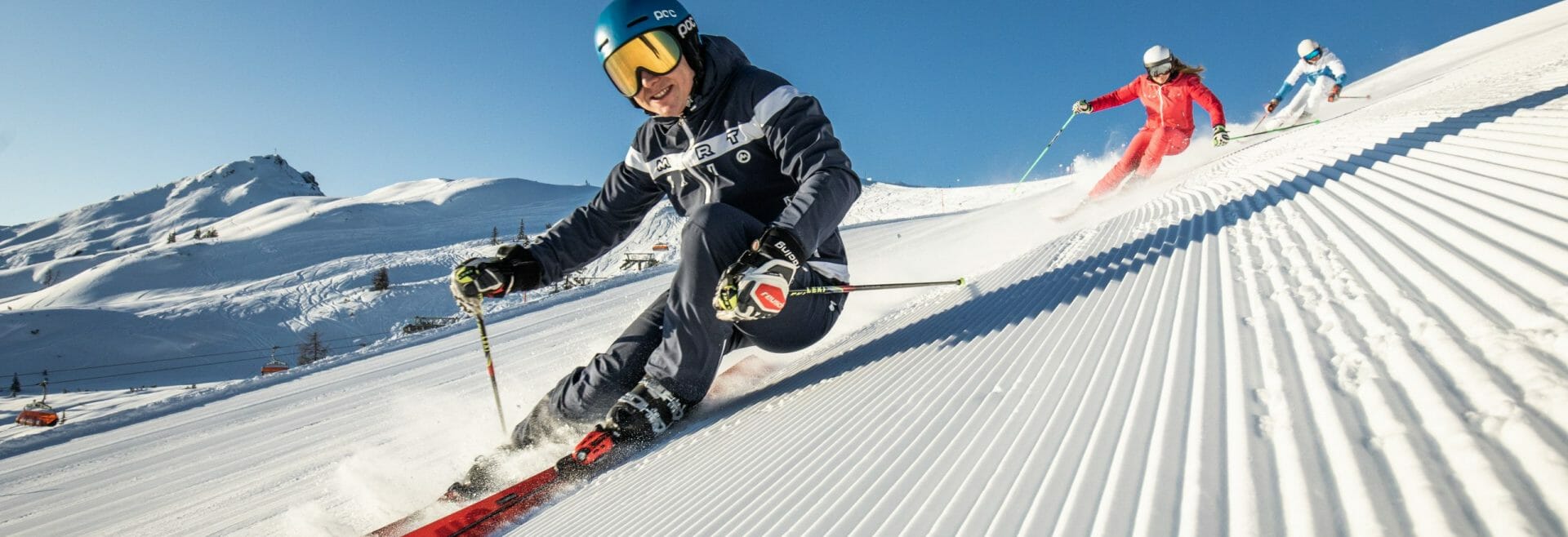 Salzbuger Sportwelt -Amade in Austria - a group of people skiing down a snowy slope.