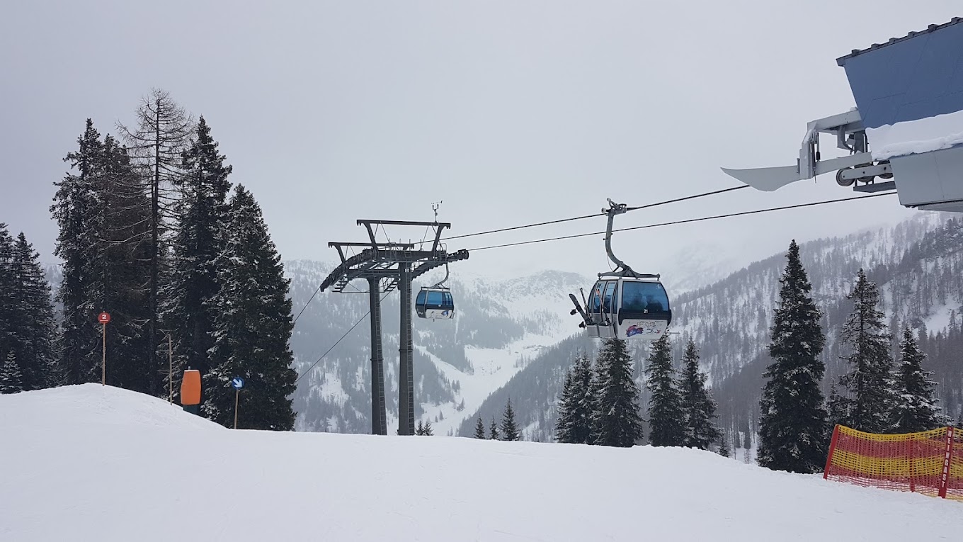 Salzbuger Sportwelt -Amade in Austria - a ski lift going up a snowy slope.