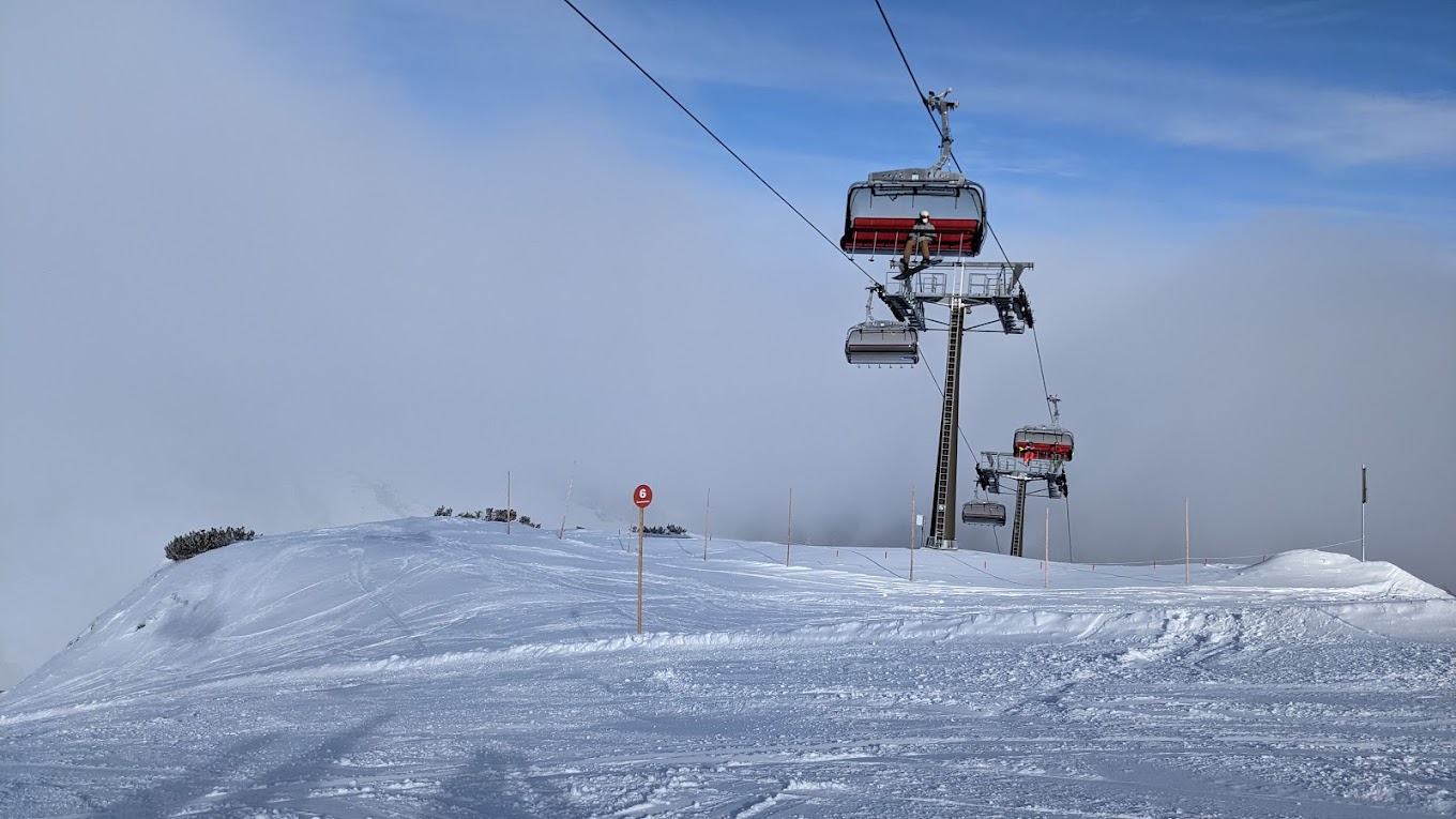 Salzbuger Sportwelt -Amade in Austria - a ski lift going up a snowy hill.