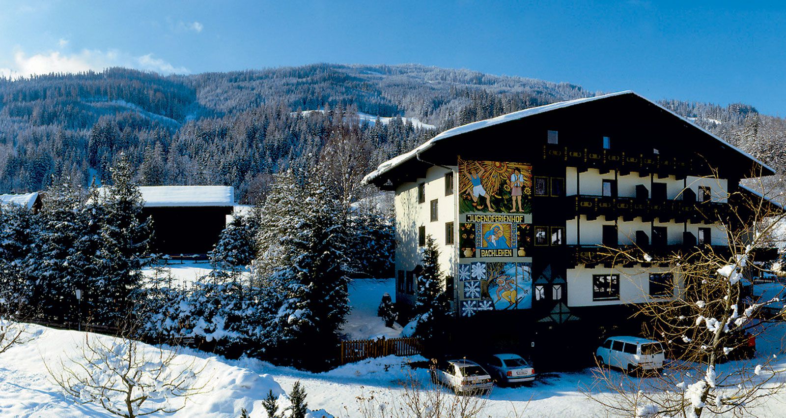 Salzbuger Sportwelt -Amade in Austria - a house in the snow with mountains in the background.