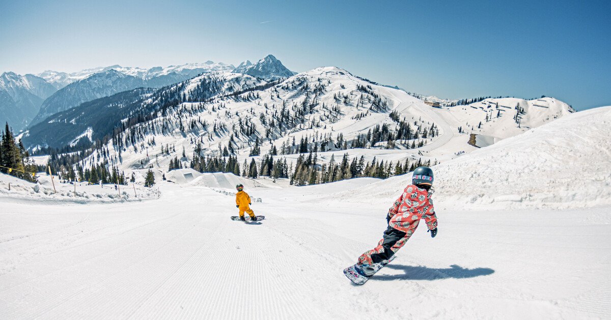 Salzbuger Sportwelt -Amade in Austria - a person on a snowboard in the snow.