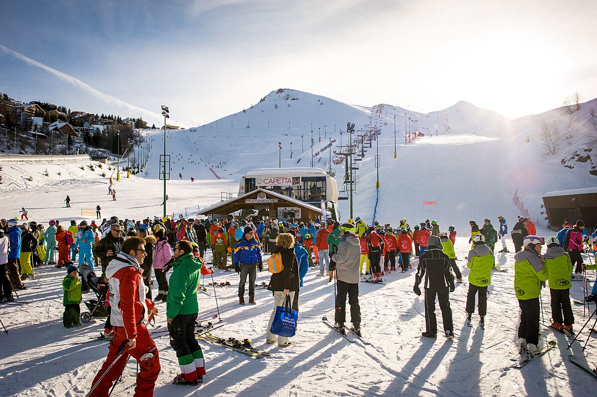 Prato in Switzerland - a group of people standing on a snow covered slope.