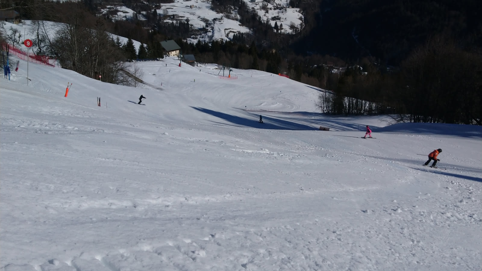 Les Rafforts – Héry sur Ugine in France - a group of people riding down a snow covered slope.
