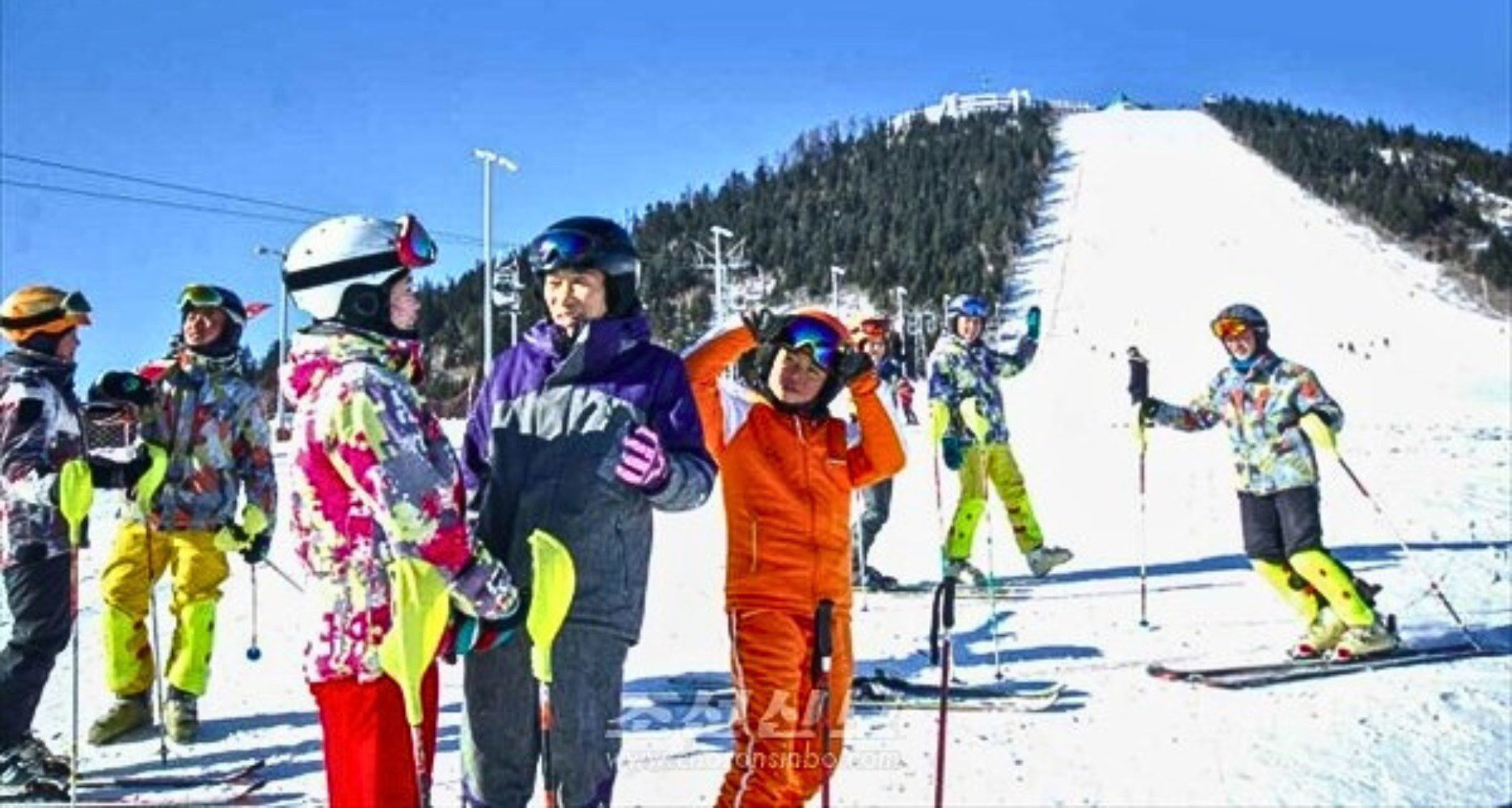 Samjiyon in North Korea - a group of people standing on top of a ski slope.