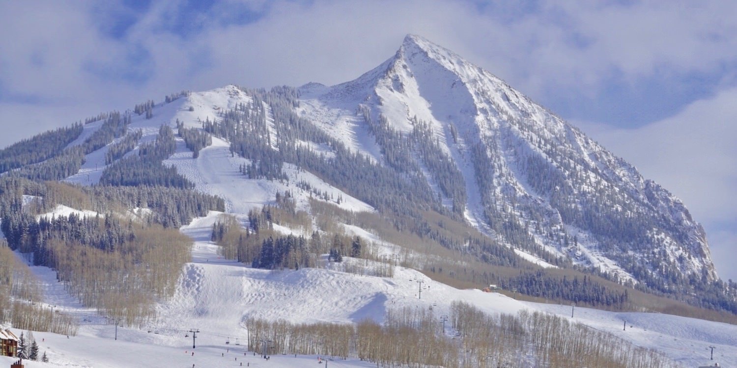 Crested Butte in USA - a group of people skiing down a snowy slope.