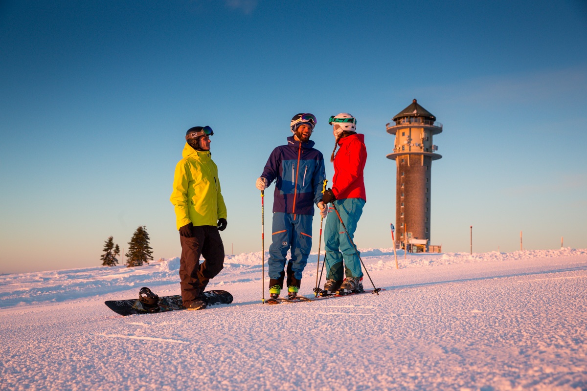 Schwarzenbachlift – Altglashütten in Germany - a group of people standing on a snow covered hill.