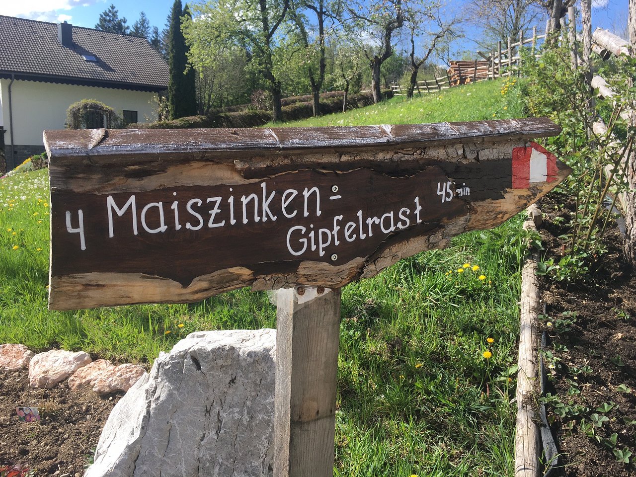 Maiszinken – Lunz am See in Austria - a wooden sign in front of a house.
