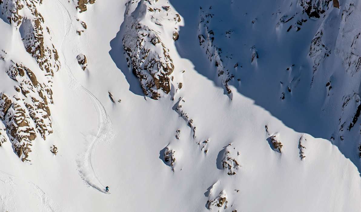 Catedral Alta Patagonia in Argentina - a person skiing down a snowy mountain.