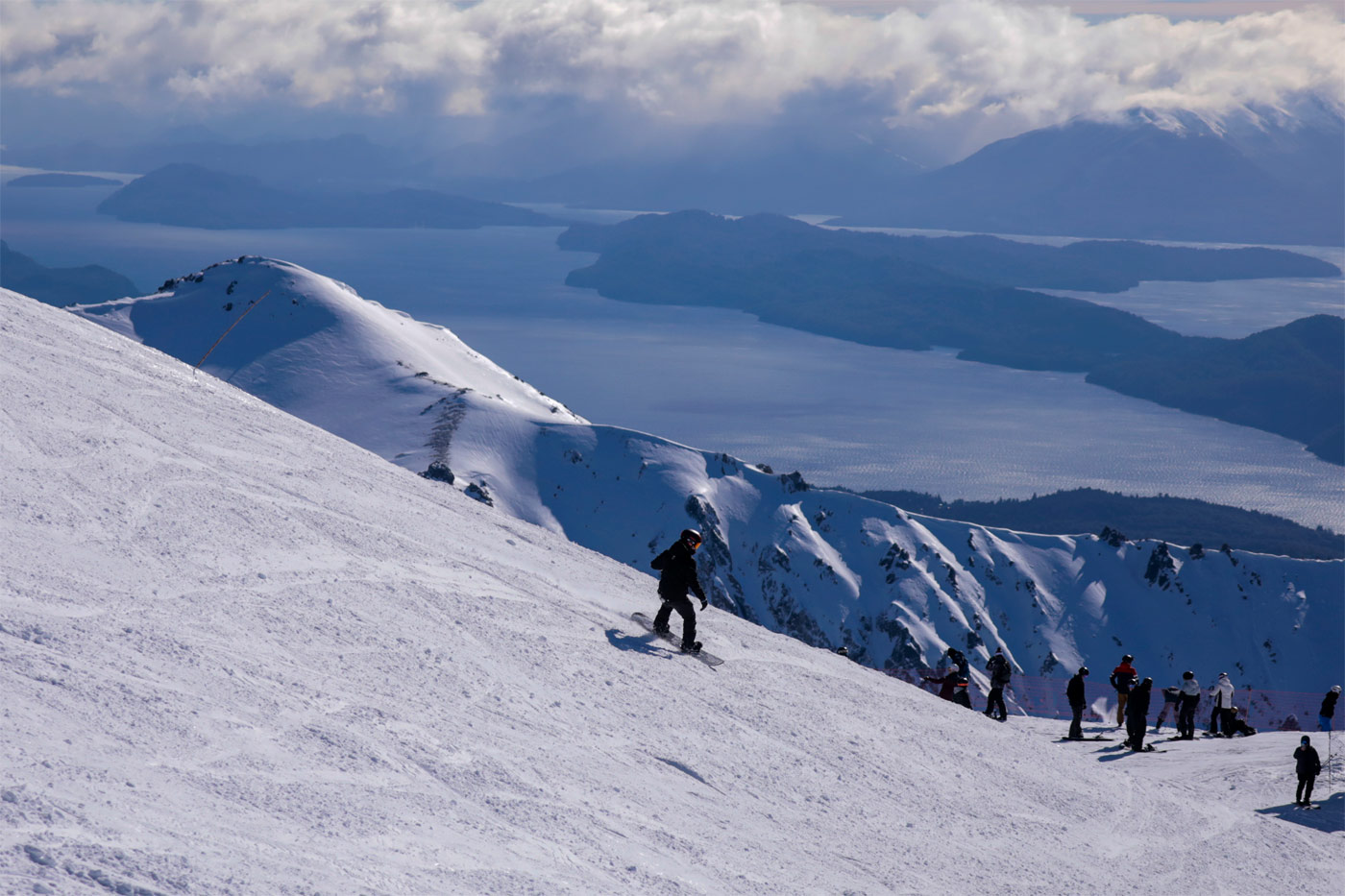 Skiers glide down snowy slopes at the bustling Catedral Alta Patagonia a popular ski resort nestled in the majestic mountains of San Carlos de Bariloche Argentina.