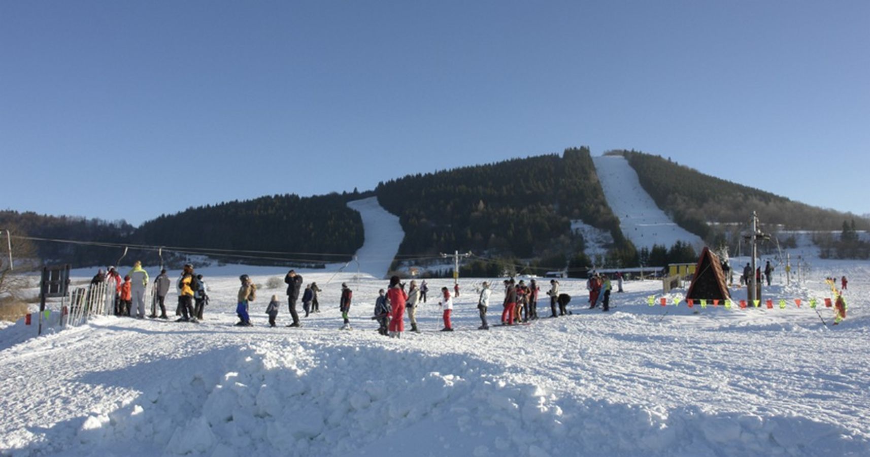 Čičmany – Javorinka in Slovakia - a group of people standing on top of a snow covered slope.