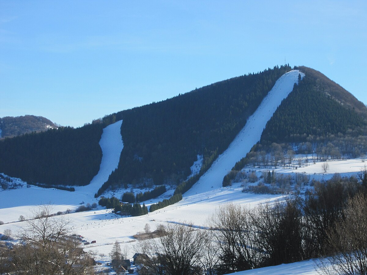 Čičmany – Javorinka in Slovakia - a snow covered mountain with trees in the fore.