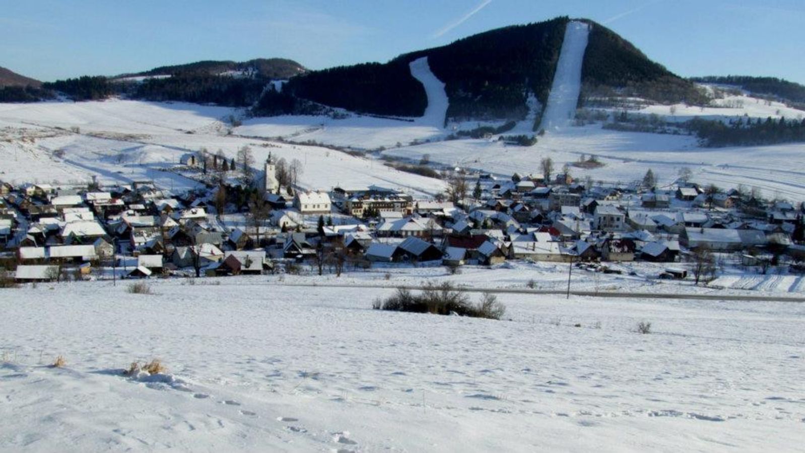 Čičmany – Javorinka in Slovakia - a small town covered in snow on a hill.