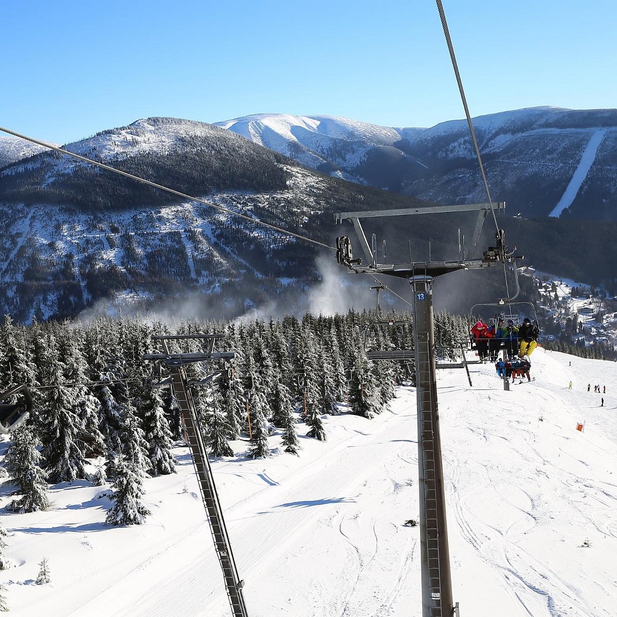 Špindlerův Mlýn in Czech Republic - a ski lift going up a snowy mountain.