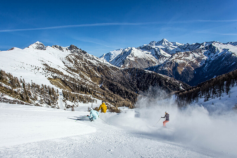 Grossglockner in Austria - a person skiing down a snowy mountain.