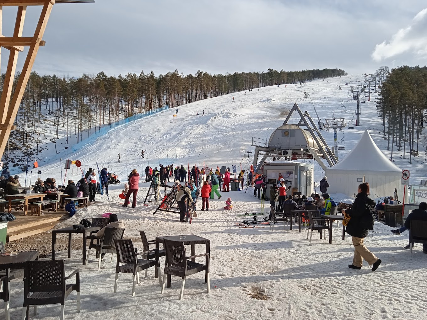 Divčibare in Serbia - a group of people sitting at a table in the snow.