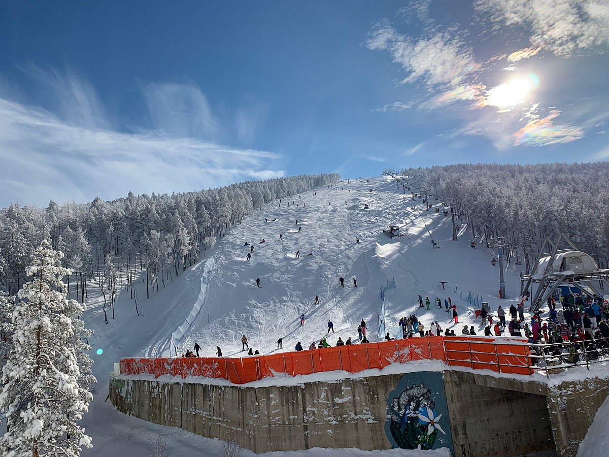 Divčibare in Serbia - a group of people standing on top of a ski slope.
