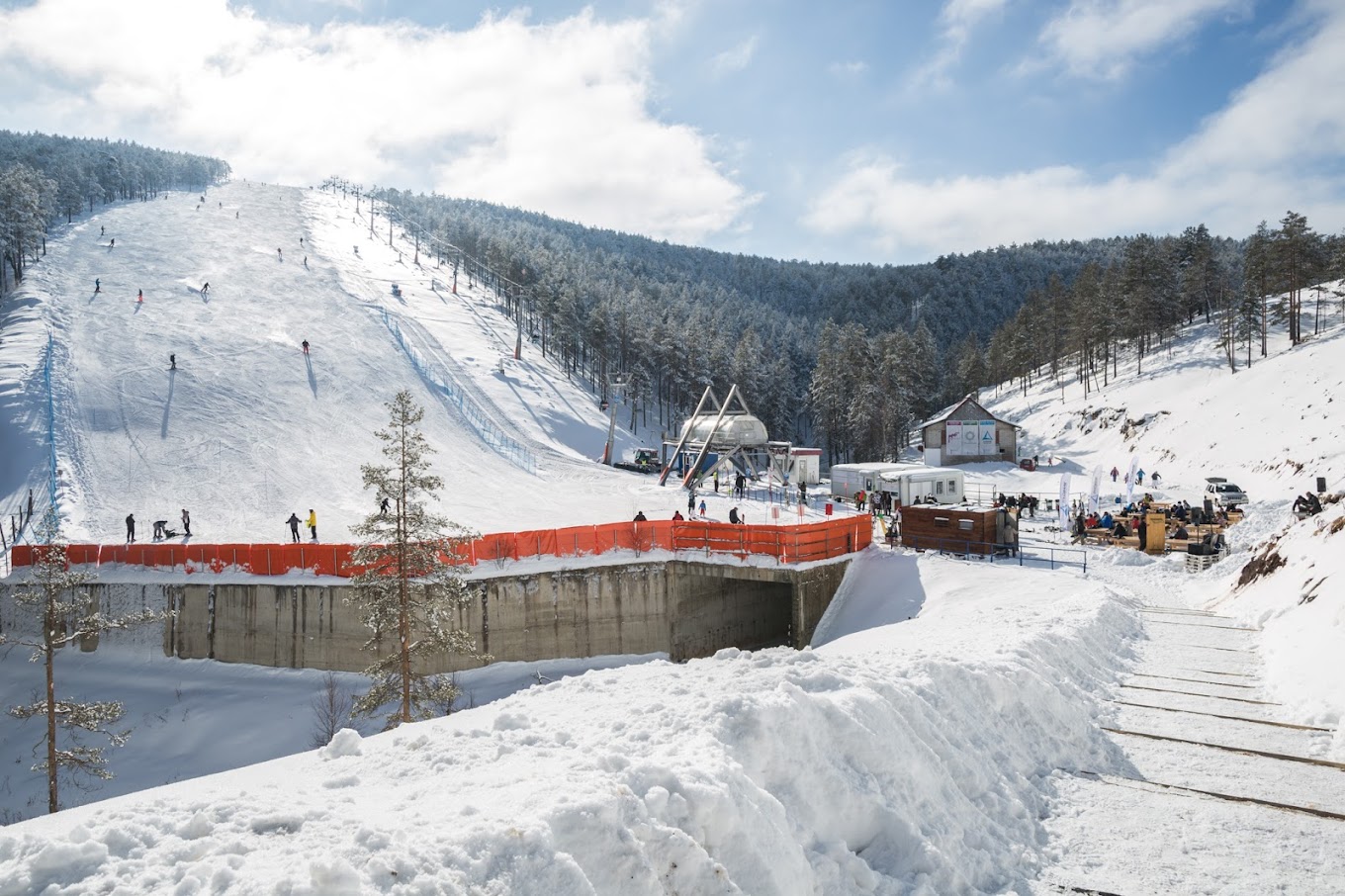 Divčibare in Serbia - a snow covered ski slope with people on it.