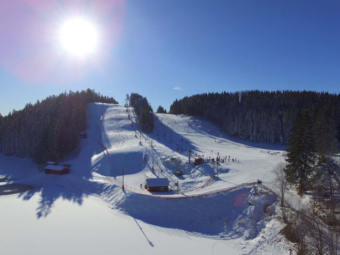 Oslo Skisenter Grefsenkollen in Norway - the sun is shining over the snow covered slopes.