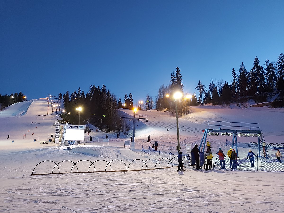 Vihti Ski Center in Finland - a group of people standing on top of a ski slope.