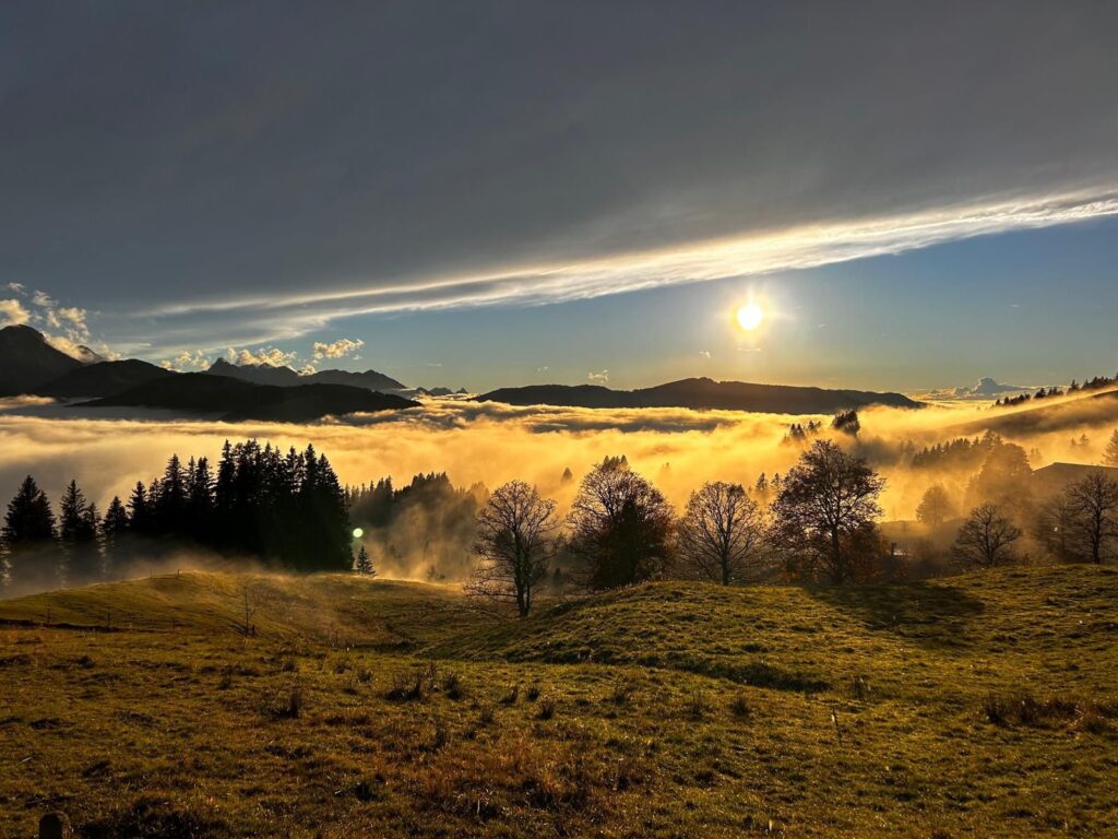 Ottenleue – Sangernboden in Switzerland - the sun shining through the clouds in the mountains.