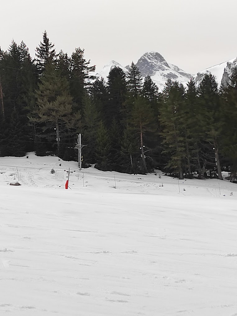 Malyovitsa in Bulgaria - a person on a snowboard in the snow.