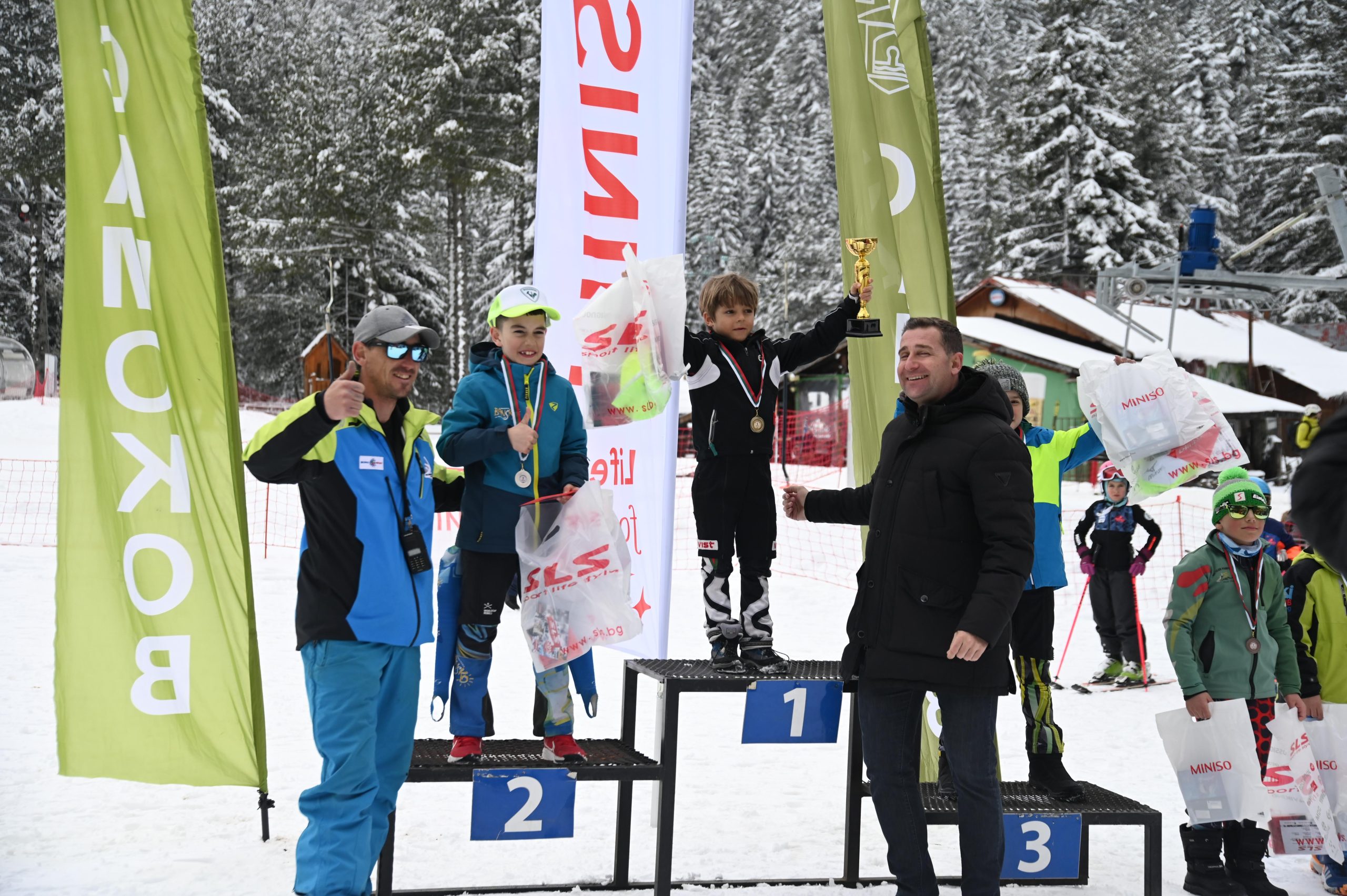 Malyovitsa in Bulgaria - a group of people standing on top of a snow covered slope.