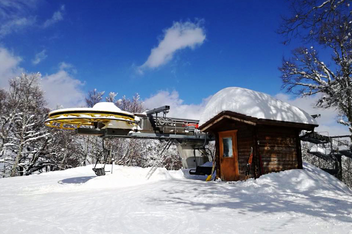 Pian Neiretto in Italy - a small cabin in the middle of a snowy forest.