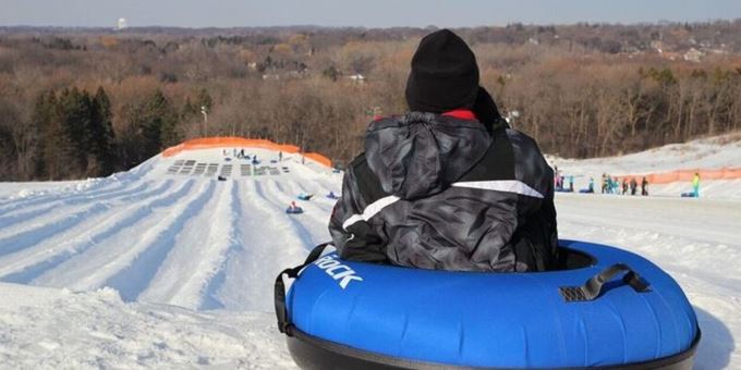A vibrant winter sports scene at The Rock Snowpark in Wisconsin USA featuring skiers enjoying the snowy slopes at the lively ski resort.