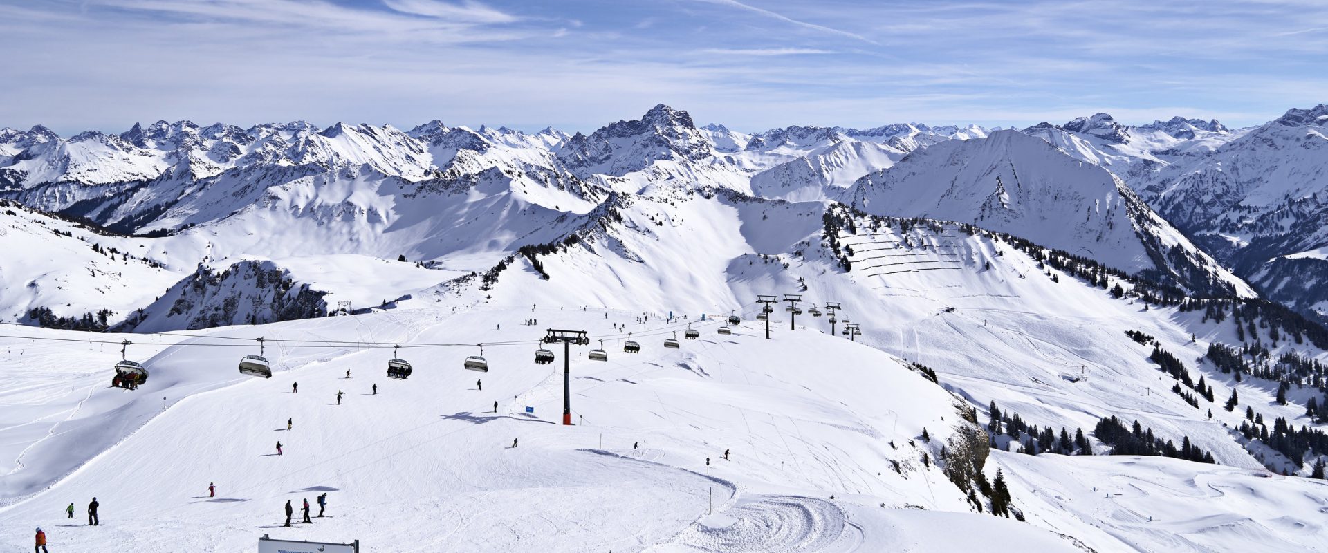 Diedamskopf – Schoppernau in Austria - a ski slope with snow covered mountains in the background.