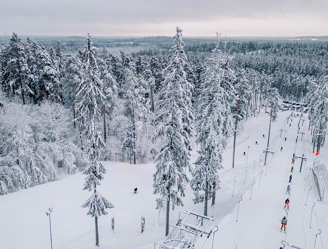 Riekstu Kalns in Latvia - a group of people skiing down a snowy slope.